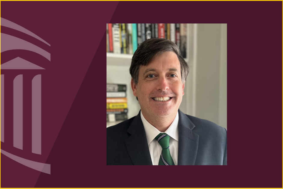 Headshot of Judge Brendan Hurson in a green tie in front of a bookshelf.